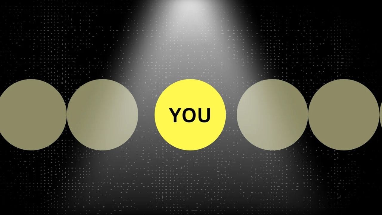 A single yellow circle with the word "YOU" inside, surrounded by several gray circles. A spotlight shines directly on the yellow circle.