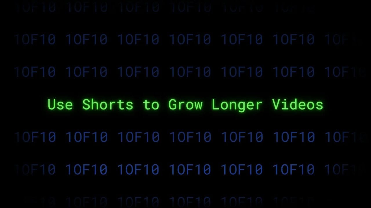 A dark screen with green text that reads "Use Shorts to Grow Longer Videos" surrounded by a matrix-like background of green and blue code.