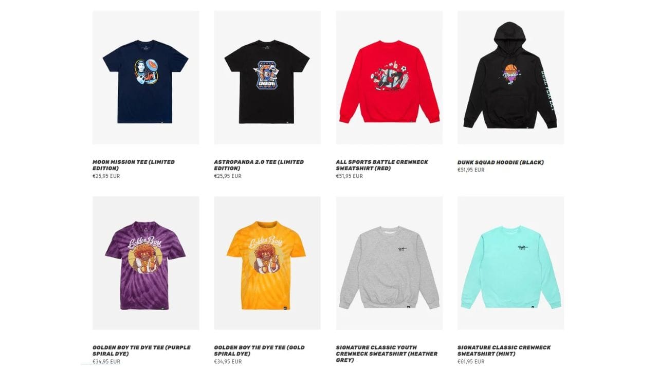 A grid of eight Dude Perfect merchandise items on a white background. The items include t-shirts in navy, black, purple tie-dye, and gold tie-dye, a red crewneck sweatshirt, a black hoodie, a heather gray crewneck sweatshirt, and a mint crewneck sweatshirt. Prices are listed in Euros (€) below each item.