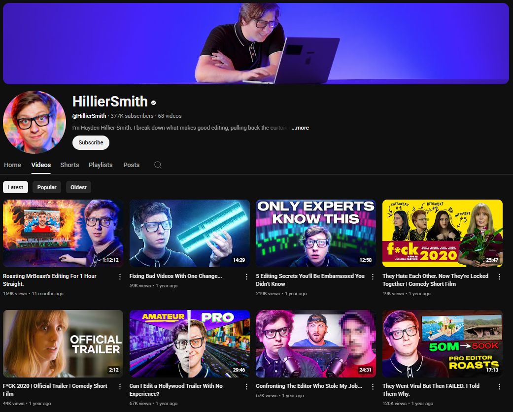 A dark-themed YouTube channel page for HillierSmith. The channel banner features Hillier Smith wearing glasses and working on a laptop, with a purple and blue gradient background. The profile picture shows Hillier Smith also wearing glasses and smiling. The channel name "HillierSmith" is in white letters, followed by a black dot. Below is the channel username "@HillierSmith", the subscriber count (377K), and the video count (68). The banner also includes the text "I'm Hayden Hillier-Smith. I break down what makes good editing, pulling back the curtain ...more" and a "Subscribe" button. The channel page displays tabs for "Home," "Videos," "Shorts," "Playlists," "Posts," and a search icon. Below these tabs are sorting options for "Latest," "Popular," and "Oldest." The video thumbnails feature Hillier Smith and often relate to video editing tips, challenges, and comedic short films, with titles like "Roasting MrBeast's Editing For 1 Hour Straight," "Fixing Bad Videos With One Change...," "5 Editing Secrets You'll Be Embarrassed You Didn't Know," "They Hate Each Other: Now They're Locked Together | Comedy Short Film," "PCK 2020 | Official Trailer | Comedy Short Film," "Can I Edit a Hollywood Trailer With No Experience?," "Confronting The Editor Who Stole My Job...," and "They Went Viral But Then Failed. I Told Them Why." 