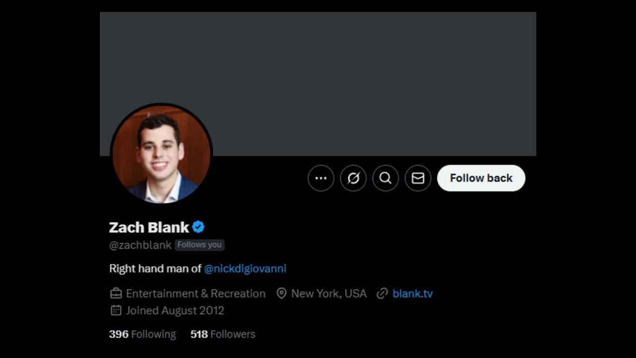 A dark-themed Twitter profile page for Zach Blank. His profile picture shows a smiling young man with short dark hair, wearing a blue suit jacket over a white shirt. His name "Zach Blank" is displayed prominently, followed by a blue verified badge and his handle "@zachblank" with a note indicating "Follows you." His bio reads "Right hand man of @nickdigiovanni." Below the bio is information indicating his interests as "Entertainment & Recreation," his location as "New York, USA," a link to "blank.tv," and that he "Joined August 2012." At the bottom, it shows he is following "396" people and has "518 Followers." The profile also displays icons for tweets, a community, search, messages, and a "Follow back" button. The overall profile presents Zach Blank as someone closely associated with the content creator Nick DiGiovanni, based in New York.